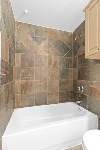 a bath tub sitting next to a white toilet