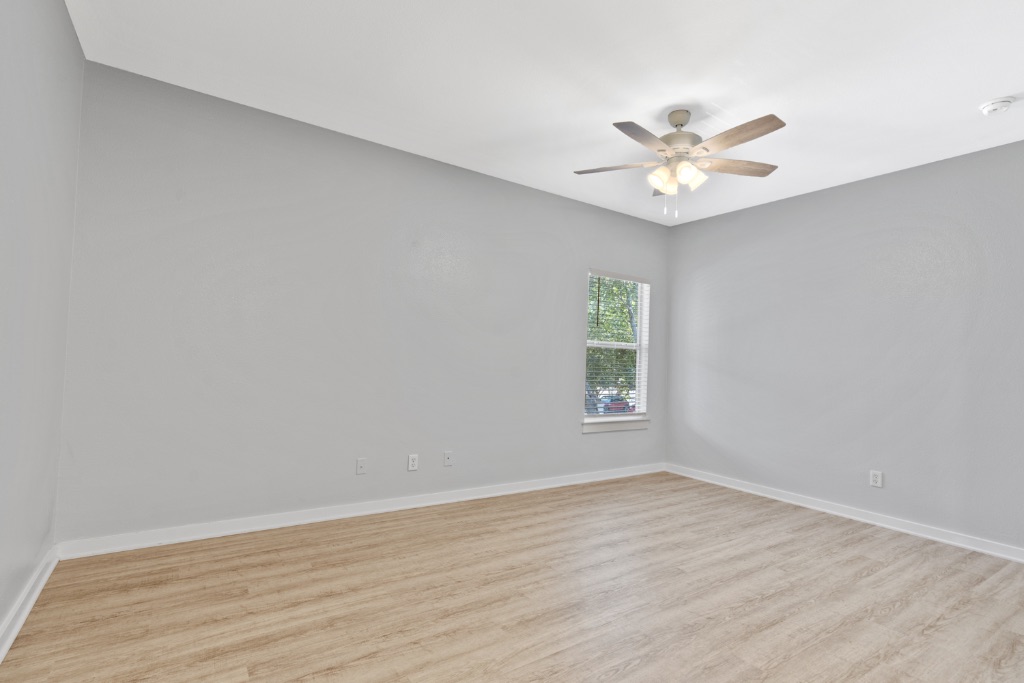 2106 Cullen Avenue, Unit 206 Austin, TX 78757 - Photo 4 of 15 an empty room with a window and a fan