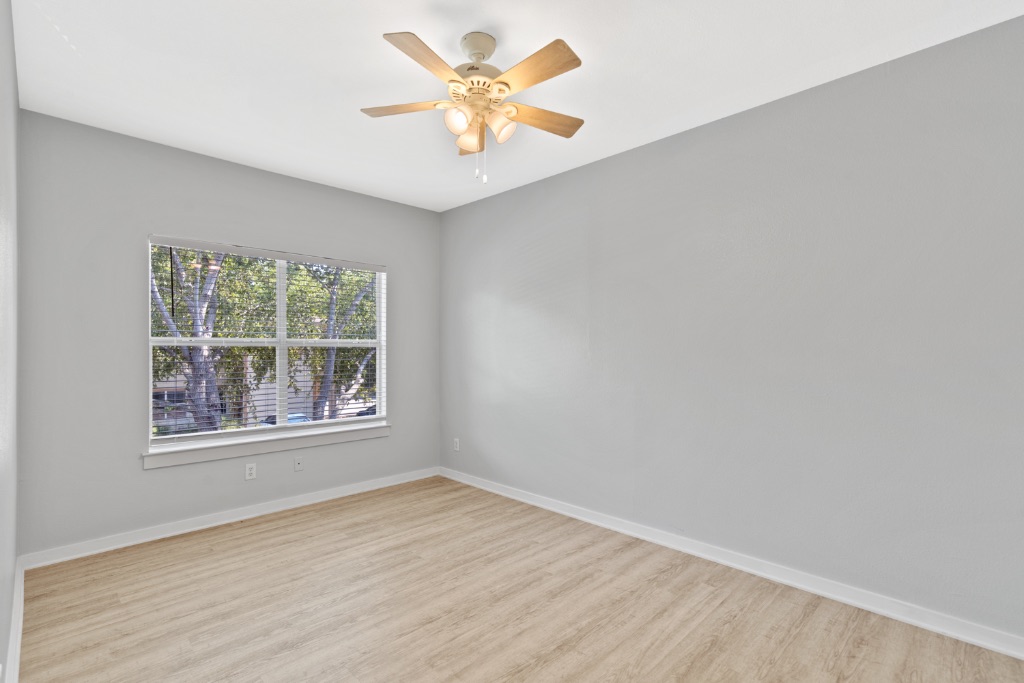 2106 Cullen Avenue, Unit 206 Austin, TX 78757 - Photo 8 of 15 an empty room with a window and a fan