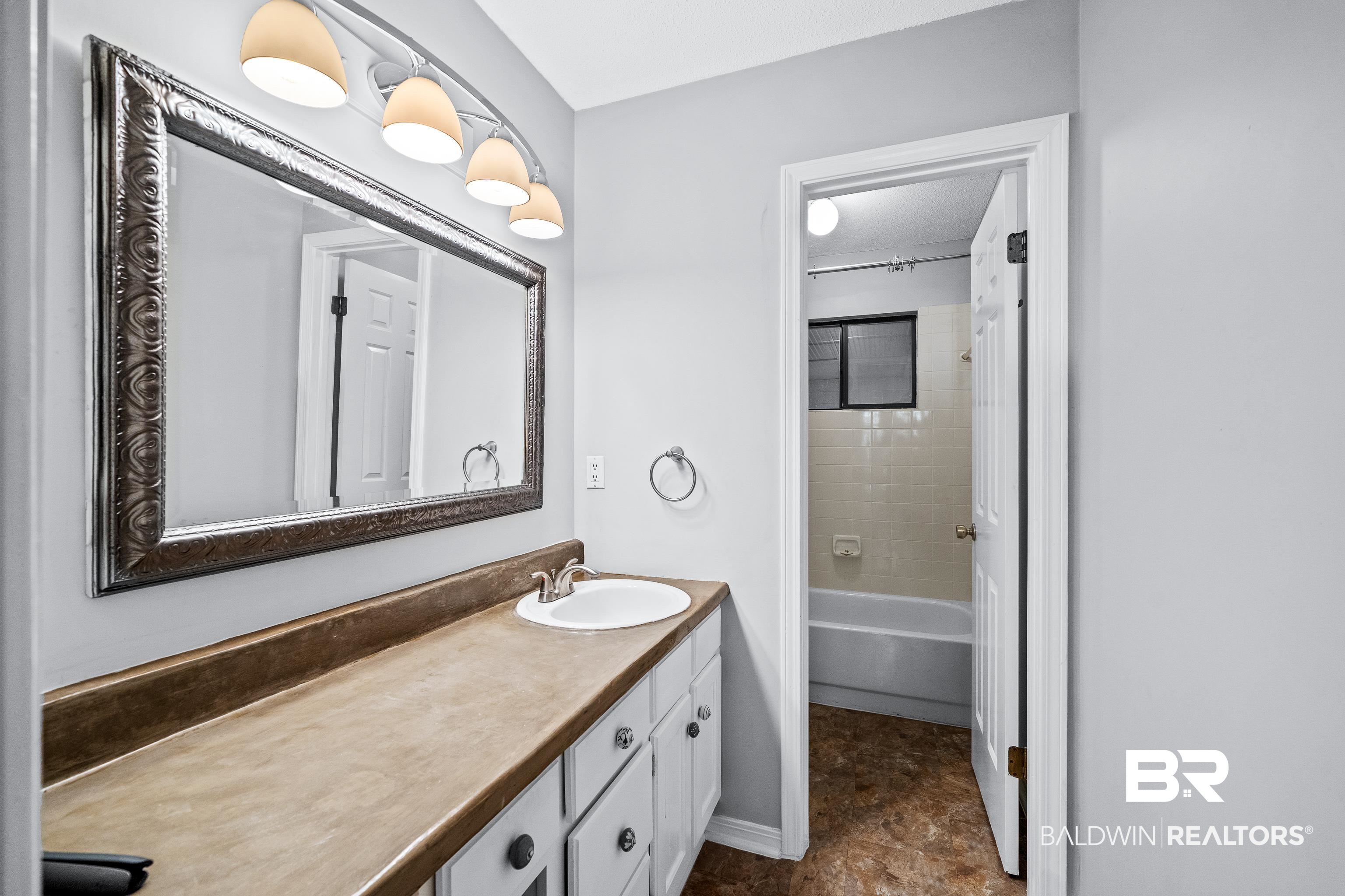 511 Ridgewood Drive Daphne, AL 36526 - Photo 24 of 59 Bathroom featuring vanity and tiled shower / bath