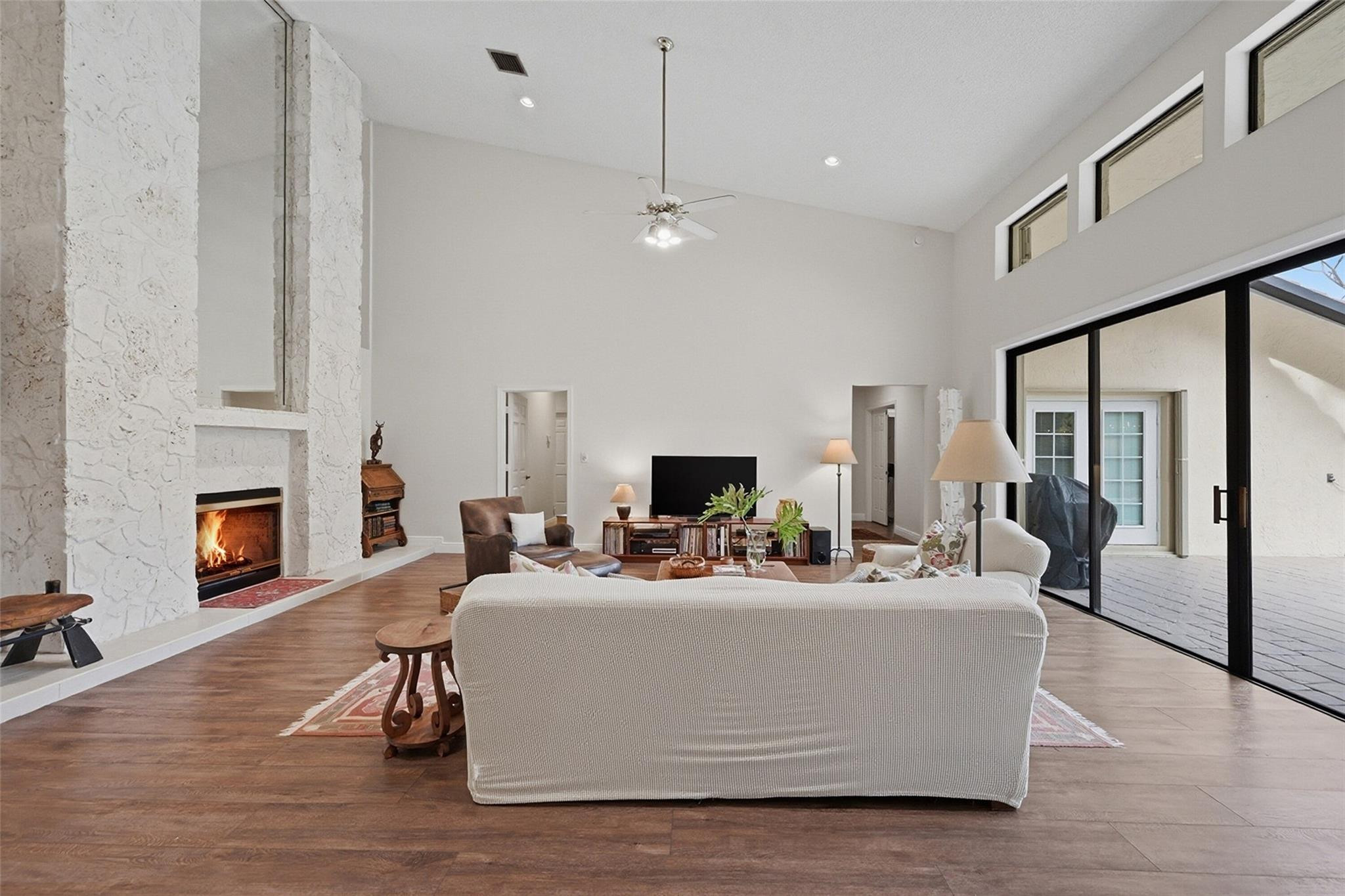 7720 West Upper Ridge Drive Parkland, FL 33067 - Photo 16 of 85 a living room with furniture a fireplace and a flat screen tv