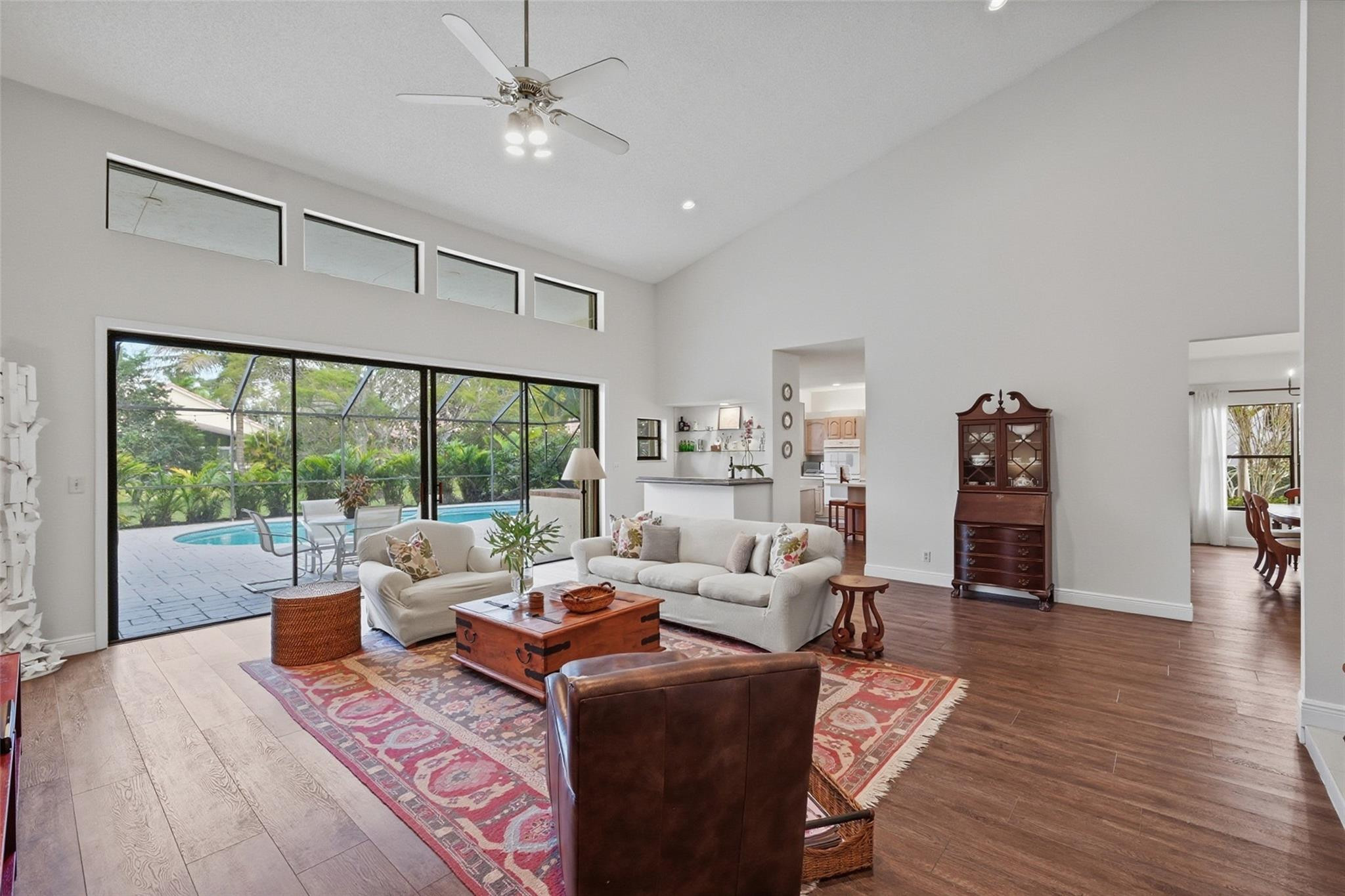 7720 West Upper Ridge Drive Parkland, FL 33067 - Photo 18 of 85 a living room with furniture and a large window with wooden floor