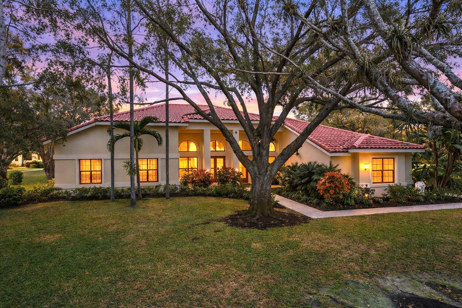 7720 West Upper Ridge Drive Parkland, FL 33067 - Photo 2 of 85 a front view of house with yard and green space