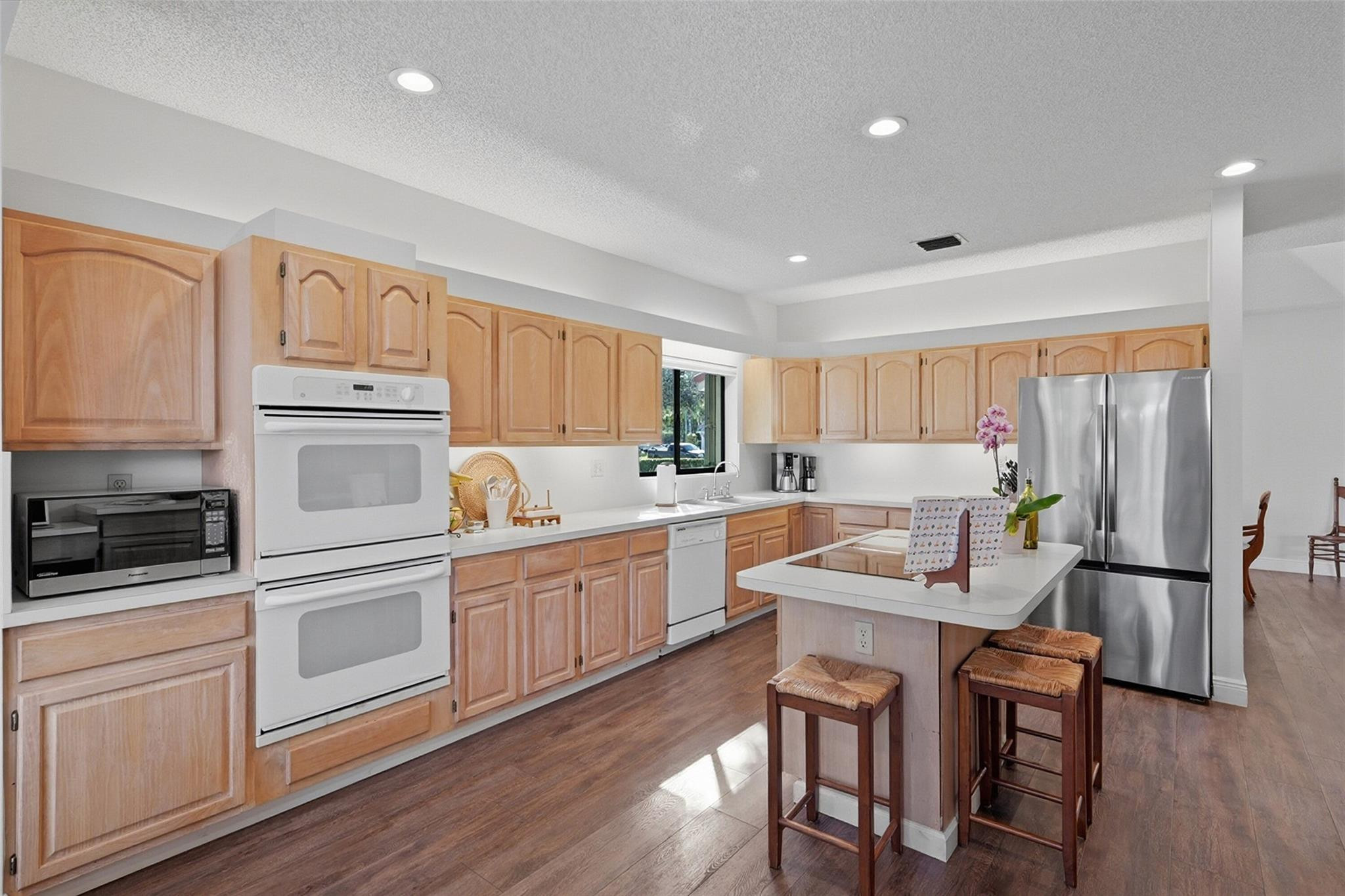 7720 West Upper Ridge Drive Parkland, FL 33067 - Photo 22 of 85 a kitchen with white cabinets and stainless steel appliances