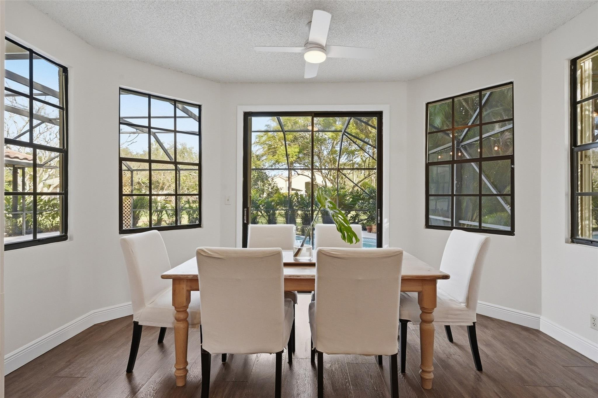 7720 West Upper Ridge Drive Parkland, FL 33067 - Photo 27 of 85 a view of a dining room with furniture windows and wooden floor