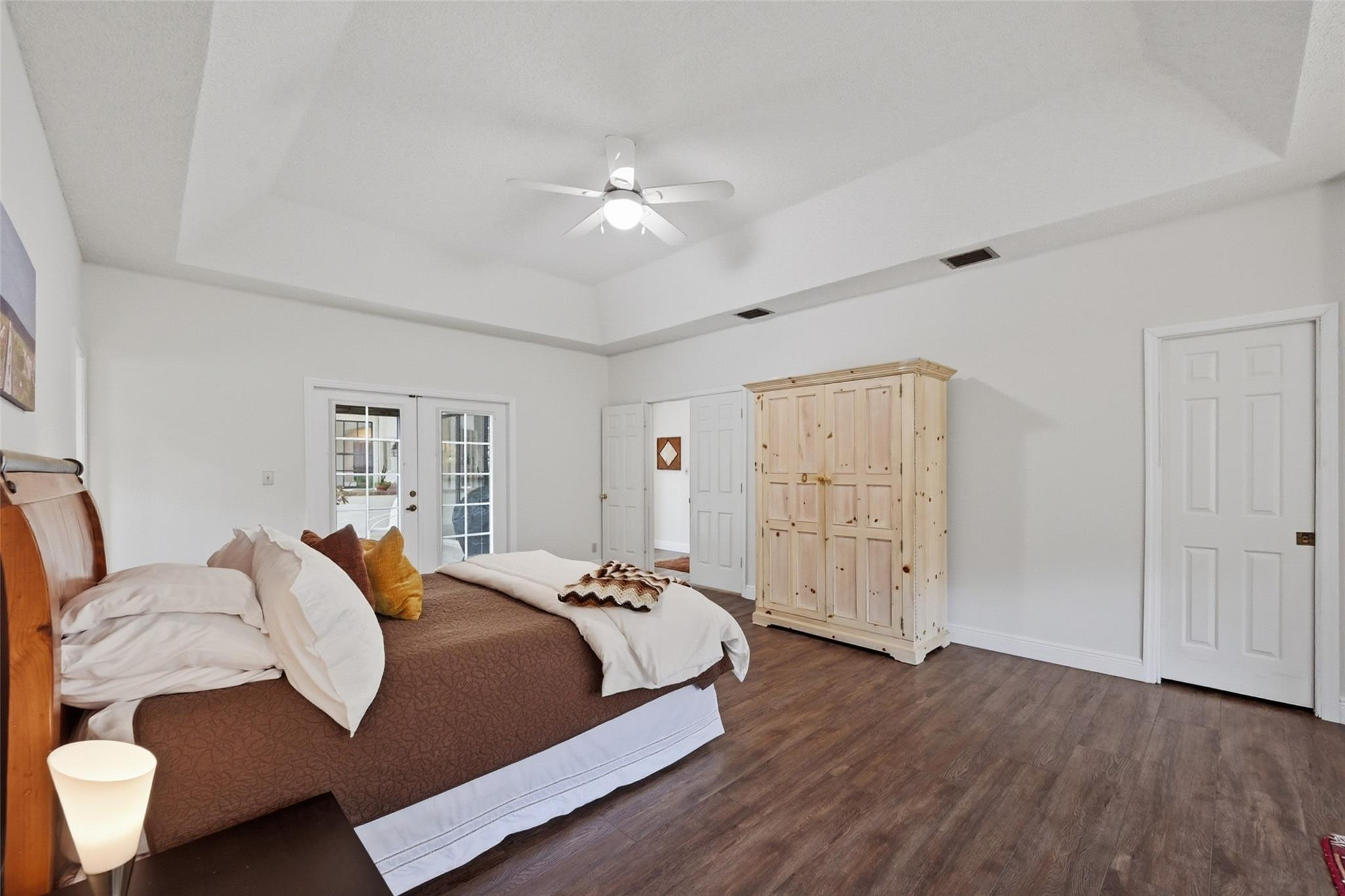7720 West Upper Ridge Drive Parkland, FL 33067 - Photo 34 of 85 a spacious bedroom with a bed and wooden floor