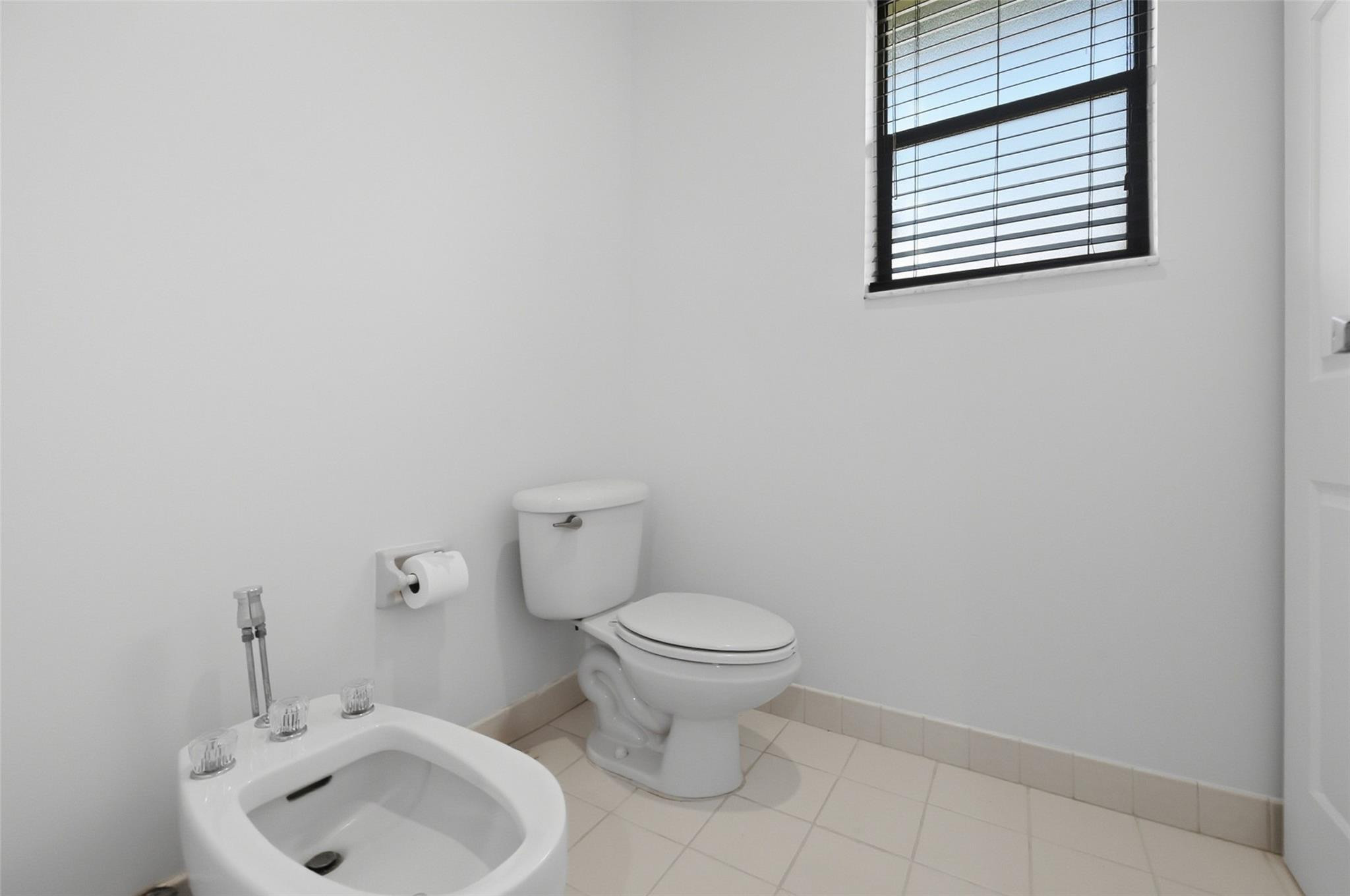 7720 West Upper Ridge Drive Parkland, FL 33067 - Photo 39 of 85 a bathroom with a toilet sink and mirror