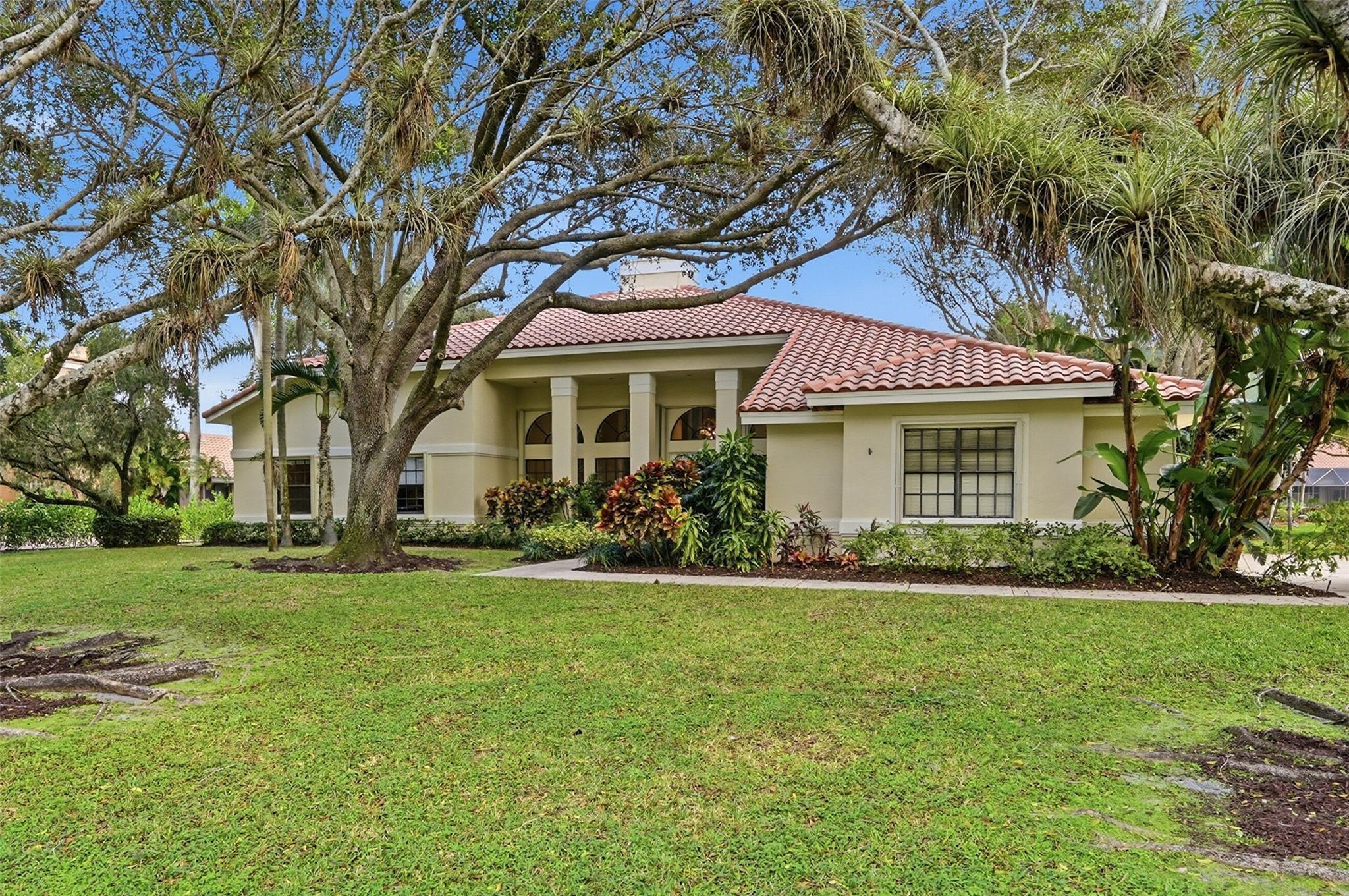 7720 West Upper Ridge Drive Parkland, FL 33067 - Photo 4 of 85 a front view of a house with a yard
