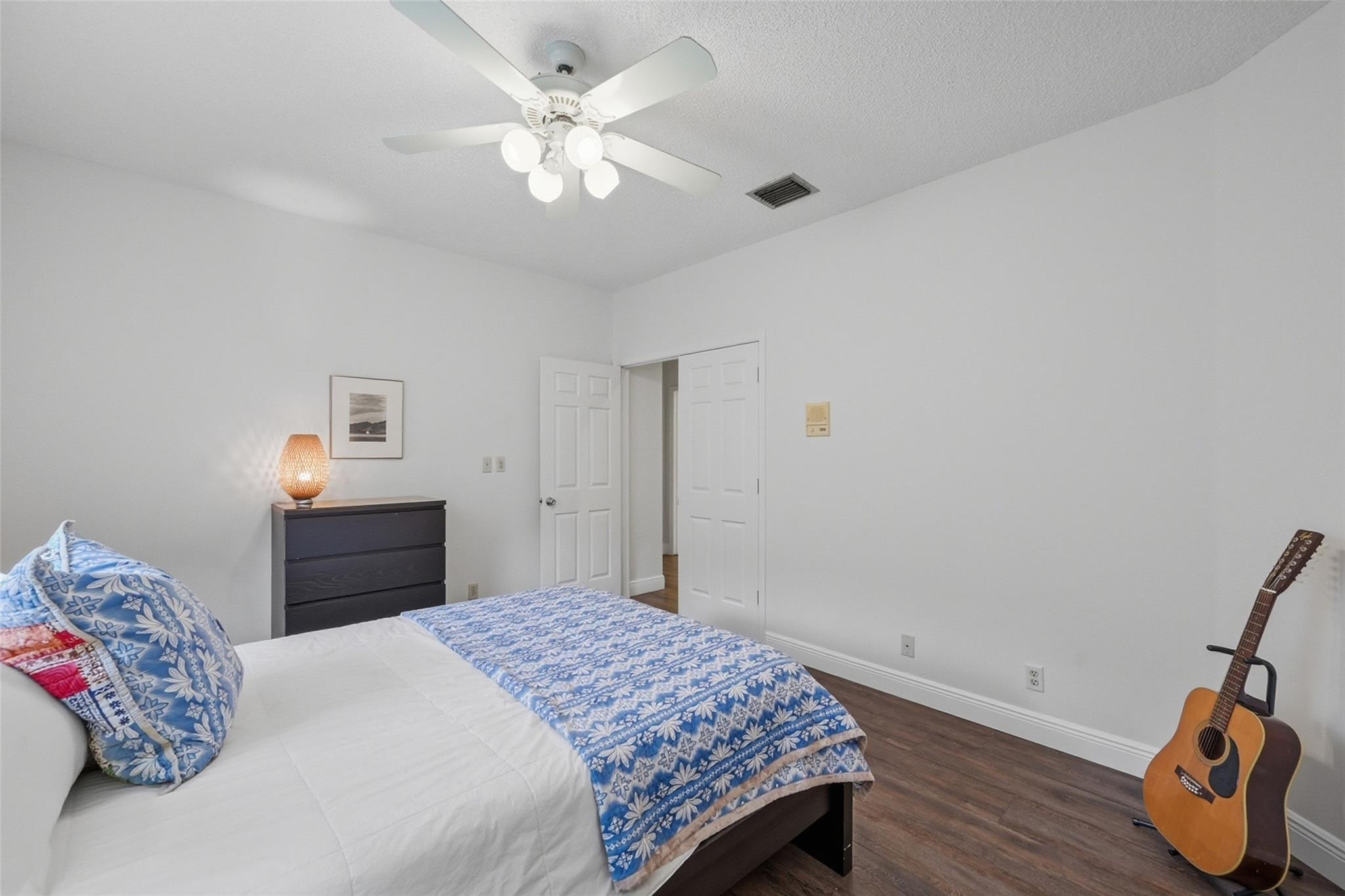 7720 West Upper Ridge Drive Parkland, FL 33067 - Photo 44 of 85 a bedroom with a bed and a chandelier