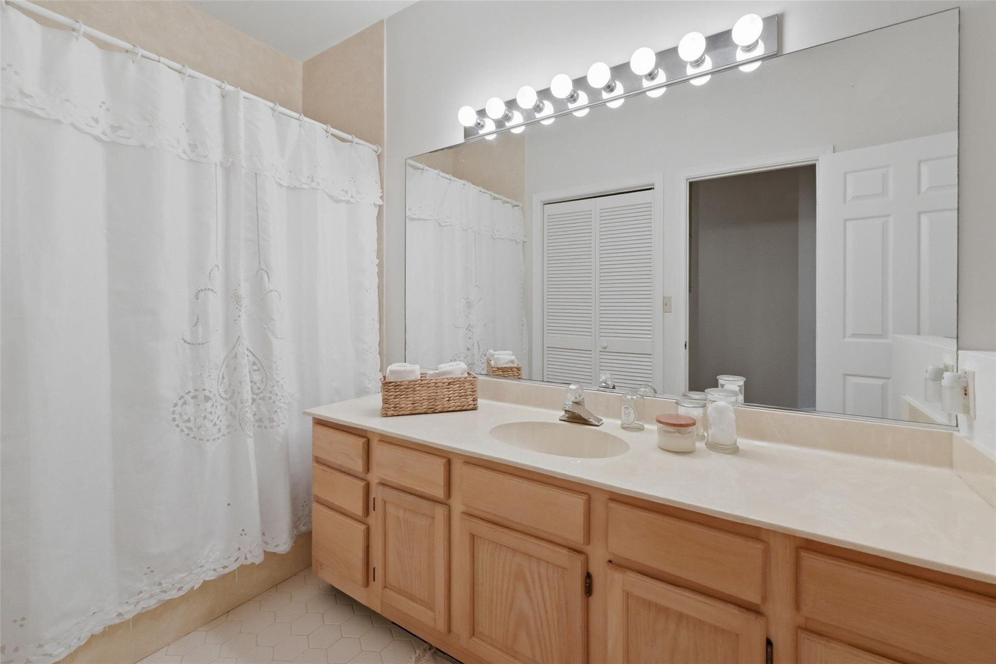 7720 West Upper Ridge Drive Parkland, FL 33067 - Photo 47 of 85 a bathroom with a double vanity sink and a mirror