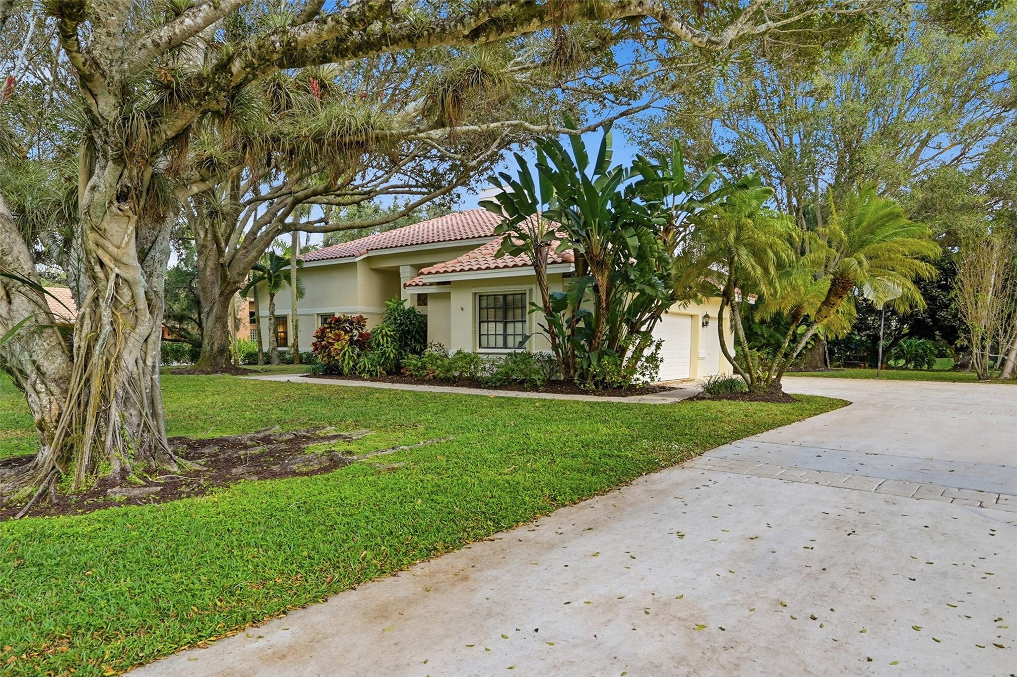 7720 West Upper Ridge Drive Parkland, FL 33067 - Photo 5 of 85 a front view of a house with a yard