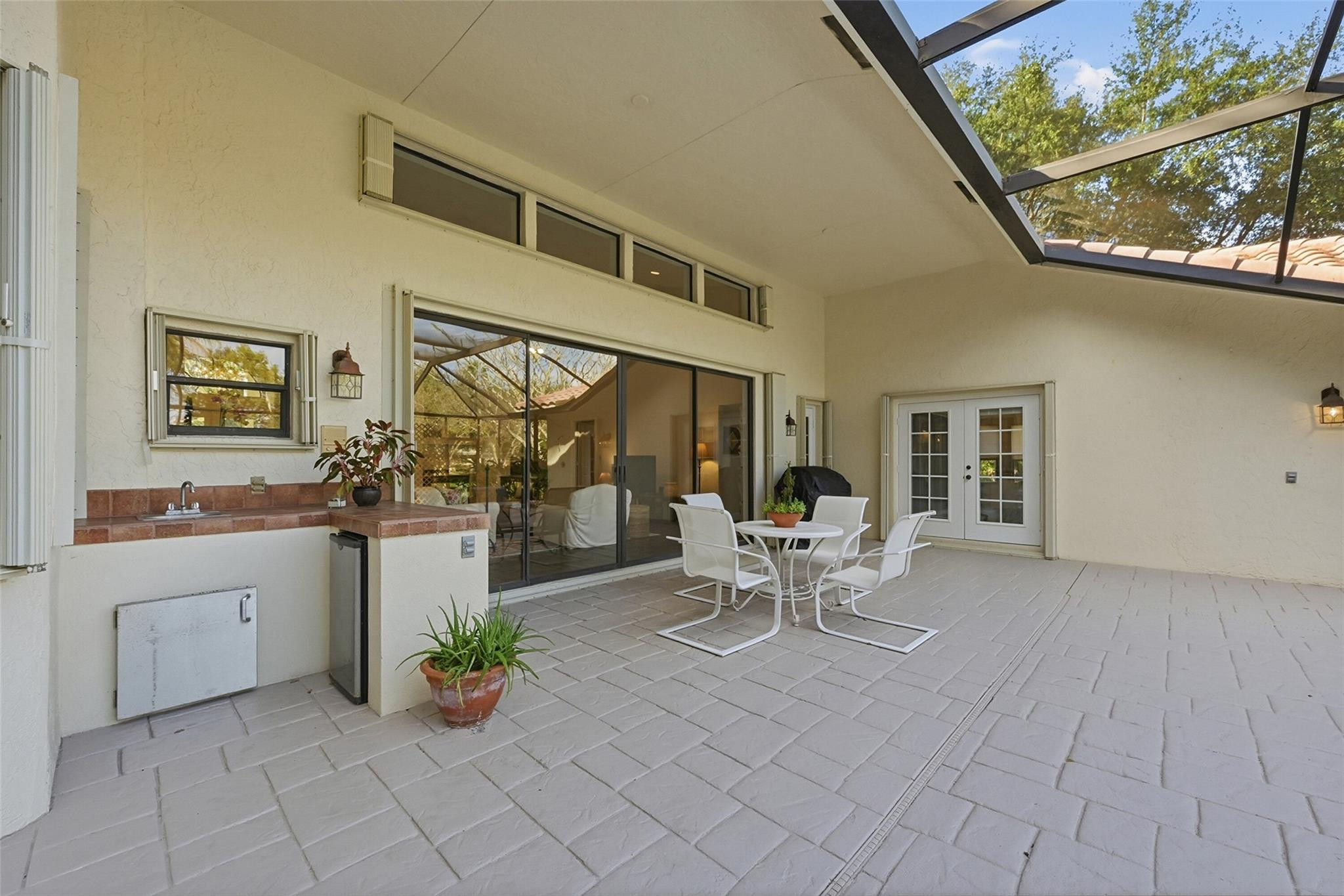 7720 West Upper Ridge Drive Parkland, FL 33067 - Photo 54 of 85 a dining room with furniture and a floor to ceiling window