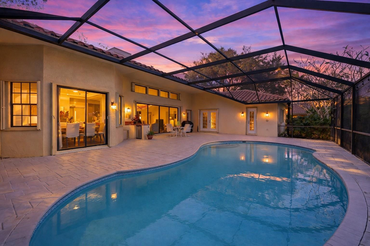 7720 West Upper Ridge Drive Parkland, FL 33067 - Photo 56 of 85 a view of a swimming pool with a patio