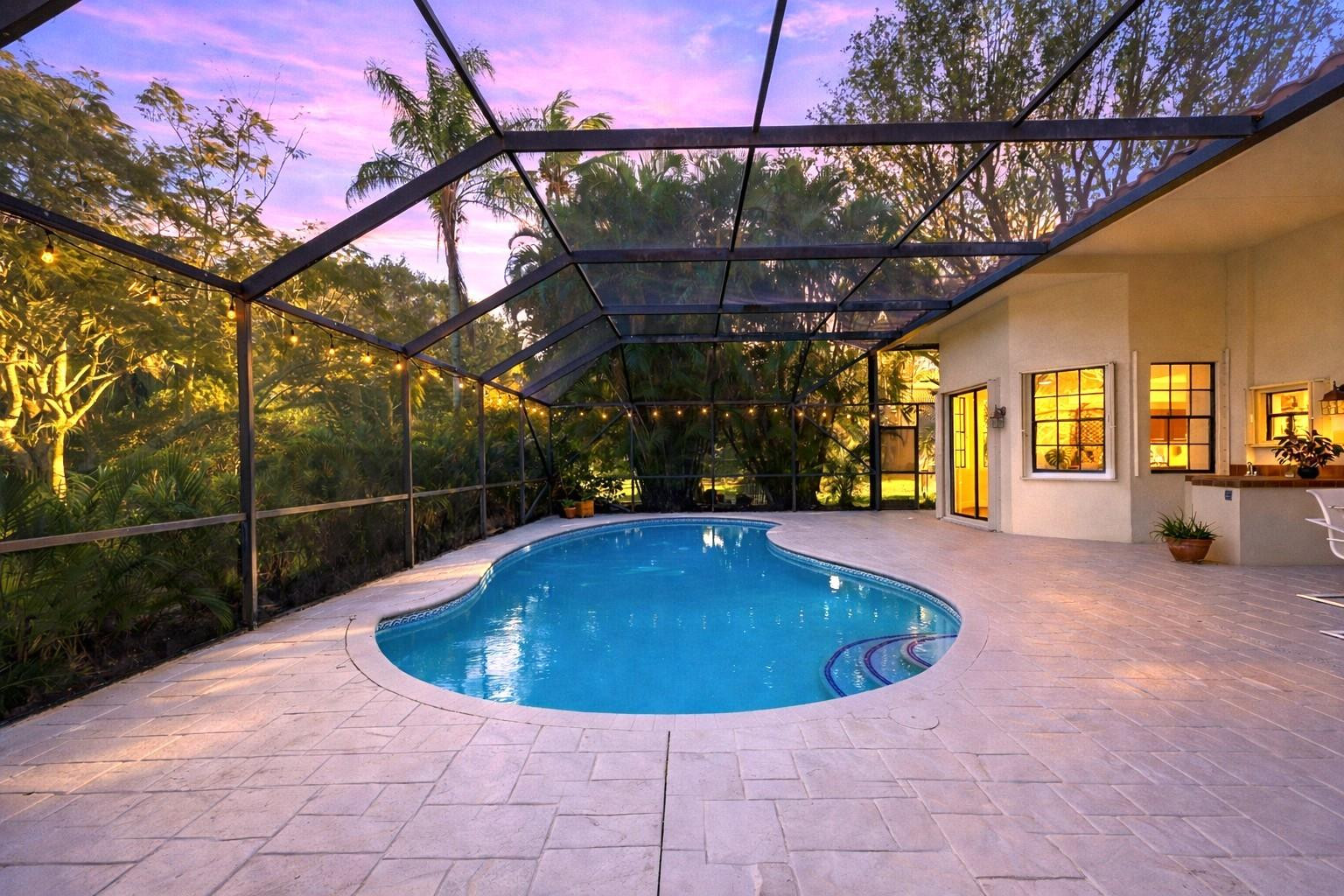 7720 West Upper Ridge Drive Parkland, FL 33067 - Photo 59 of 85 a view of a swimming pool with a patio