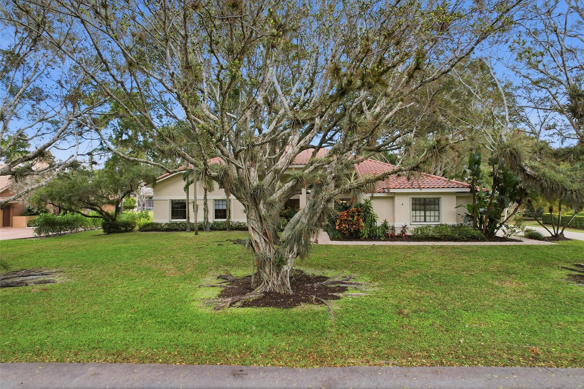 7720 West Upper Ridge Drive Parkland, FL 33067 - Photo 64 of 85 a front view of a house with a yard