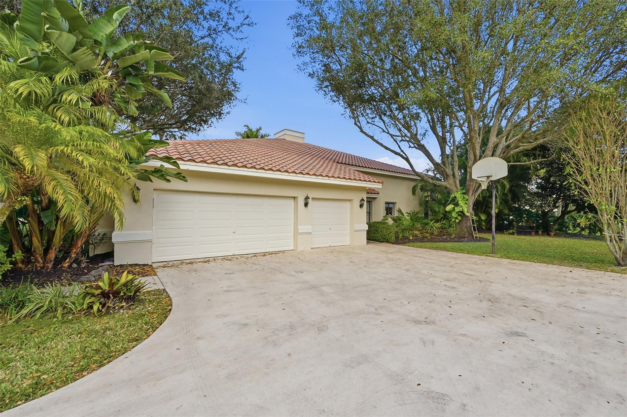 7720 West Upper Ridge Drive Parkland, FL 33067 - Photo 66 of 85 front view of a house with a trees