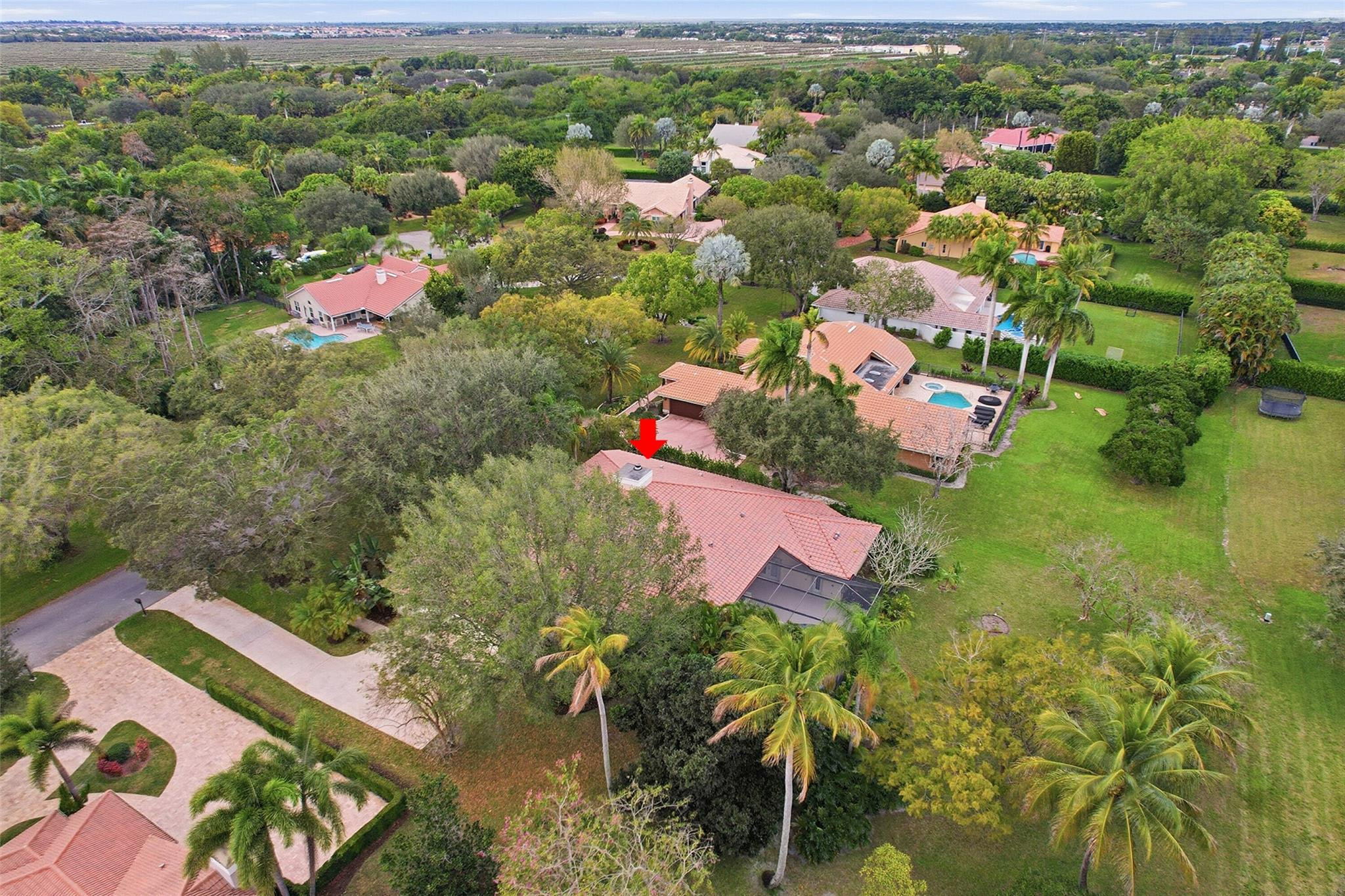 7720 West Upper Ridge Drive Parkland, FL 33067 - Photo 70 of 85 an aerial view of residential houses with outdoor space and trees
