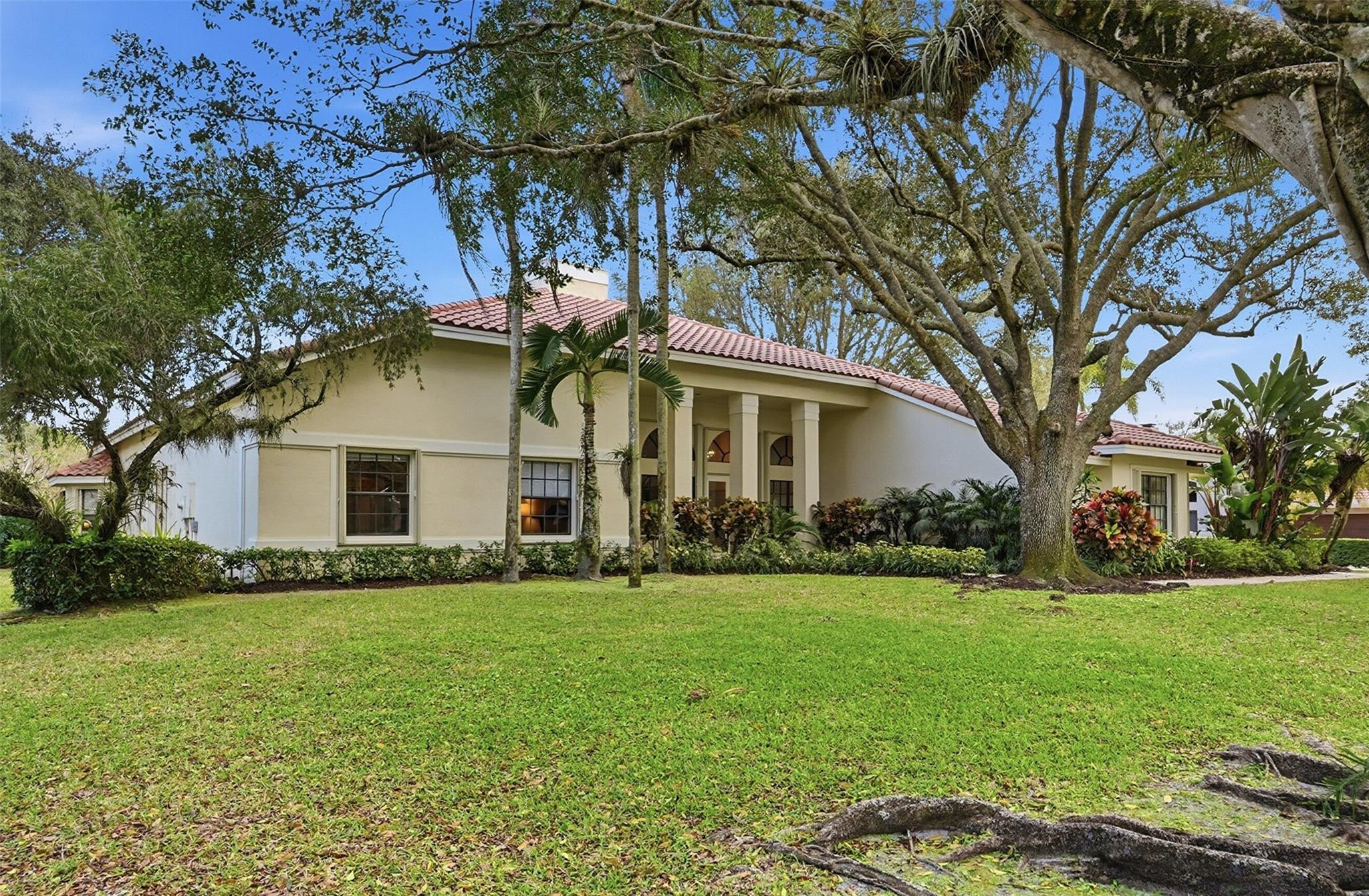 7720 West Upper Ridge Drive Parkland, FL 33067 - Photo 7 of 85 a front view of a house with a garden