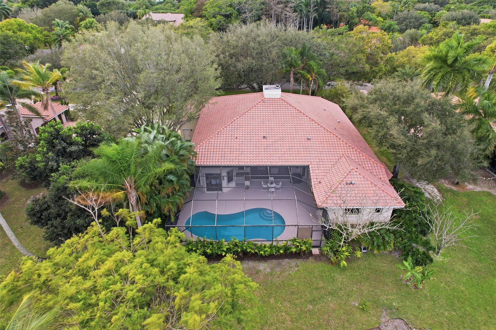 7720 West Upper Ridge Drive Parkland, FL 33067 - Photo 72 of 85 an aerial view of a house with a yard and large tree