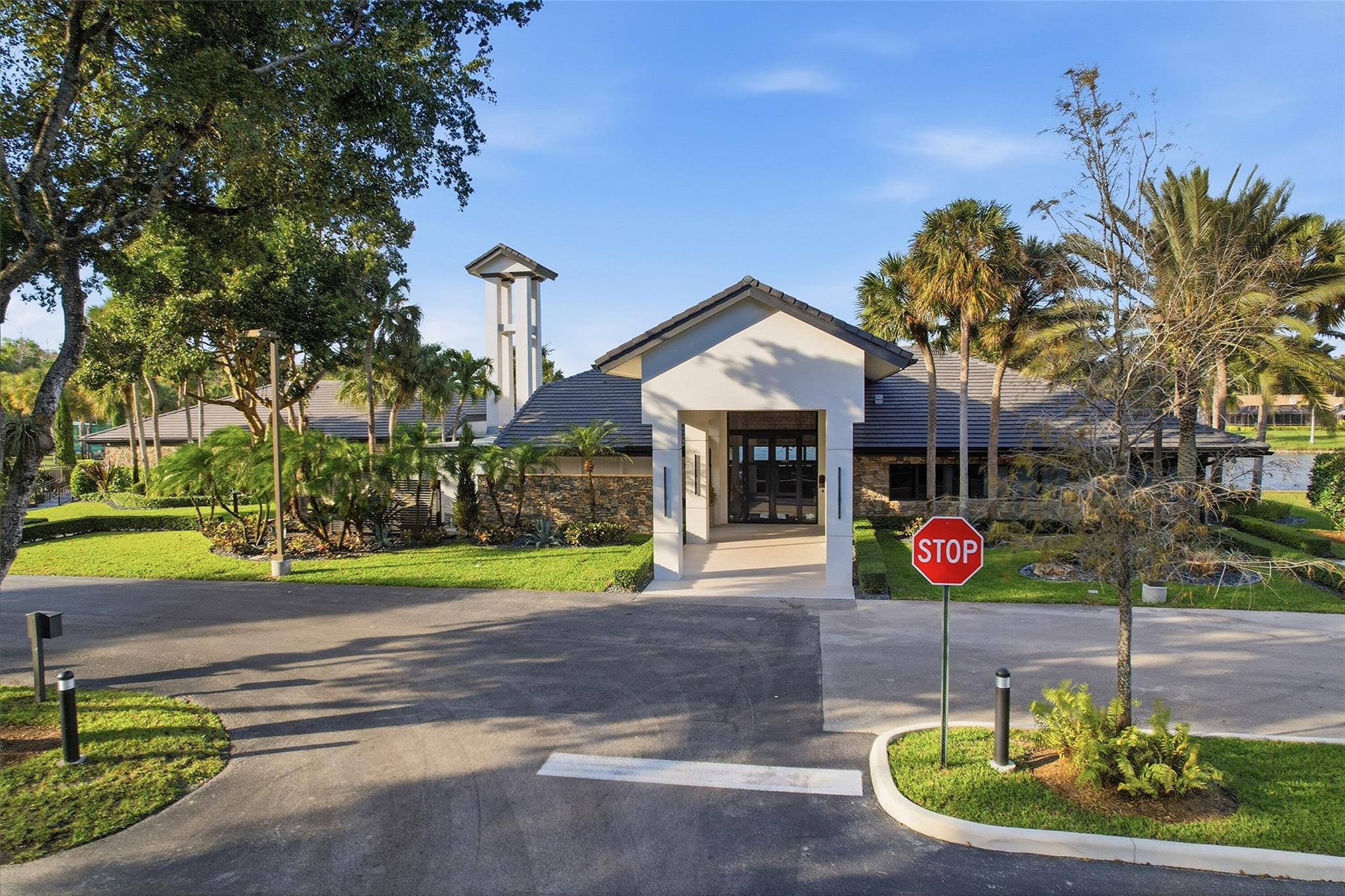 7720 West Upper Ridge Drive Parkland, FL 33067 - Photo 78 of 85 a front view of a house with a yard and potted plants