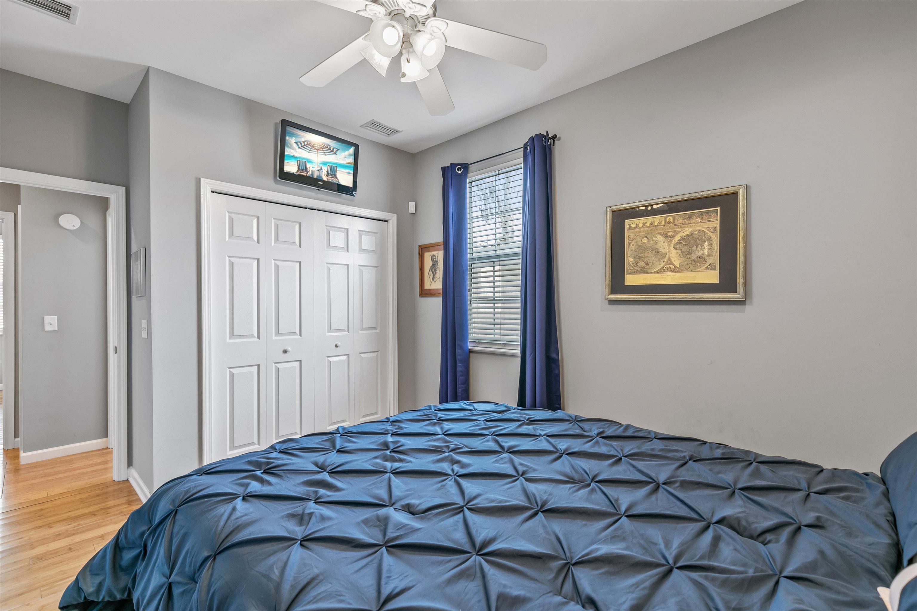 171 Riberia Street St. Augustine, FL 32084 - Photo 13 of 33 a bedroom with a large bed and a chandelier