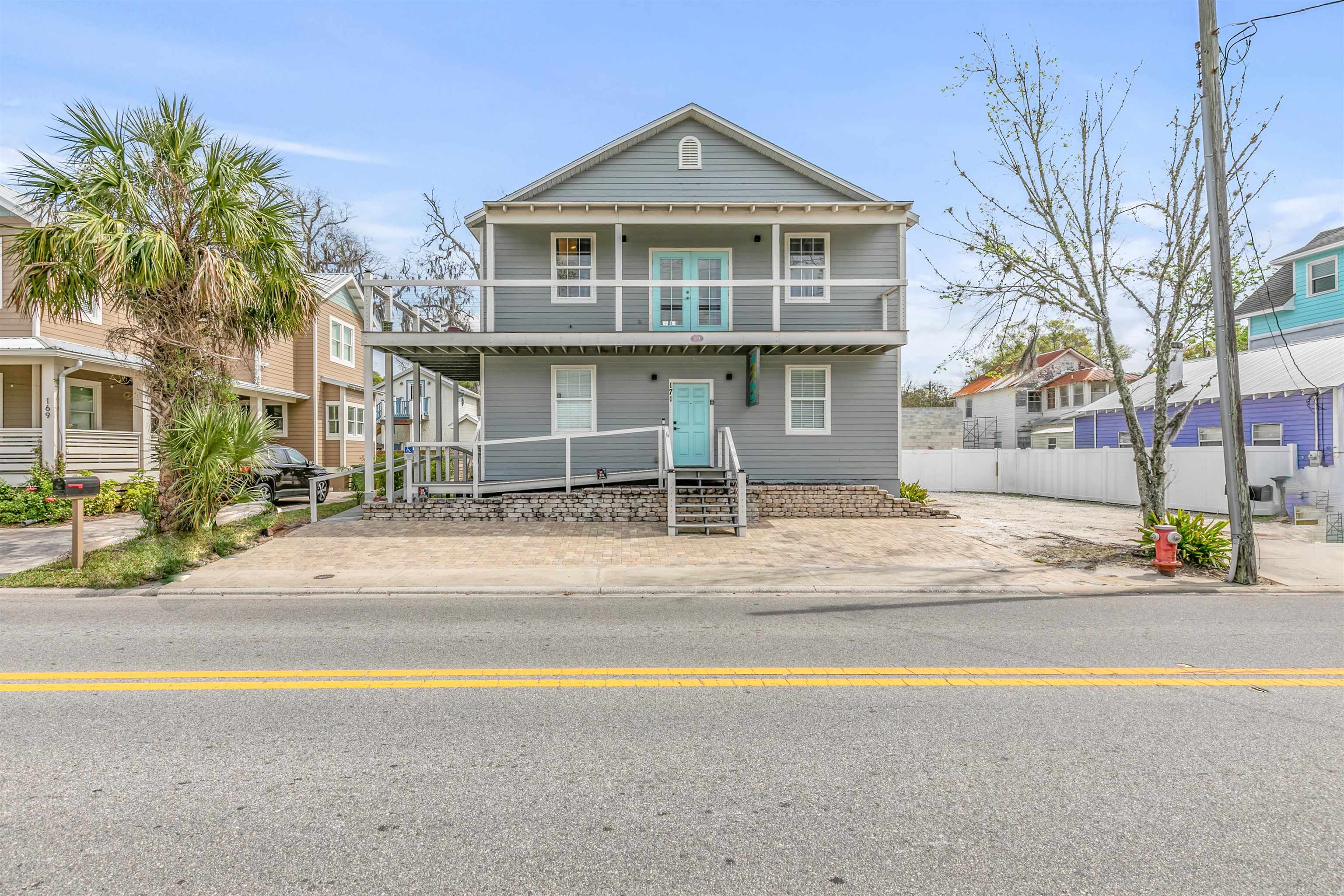 171 Riberia Street St. Augustine, FL 32084 - Photo 2 of 33 a view of a house with a swimming pool and a chairs and table in a patio