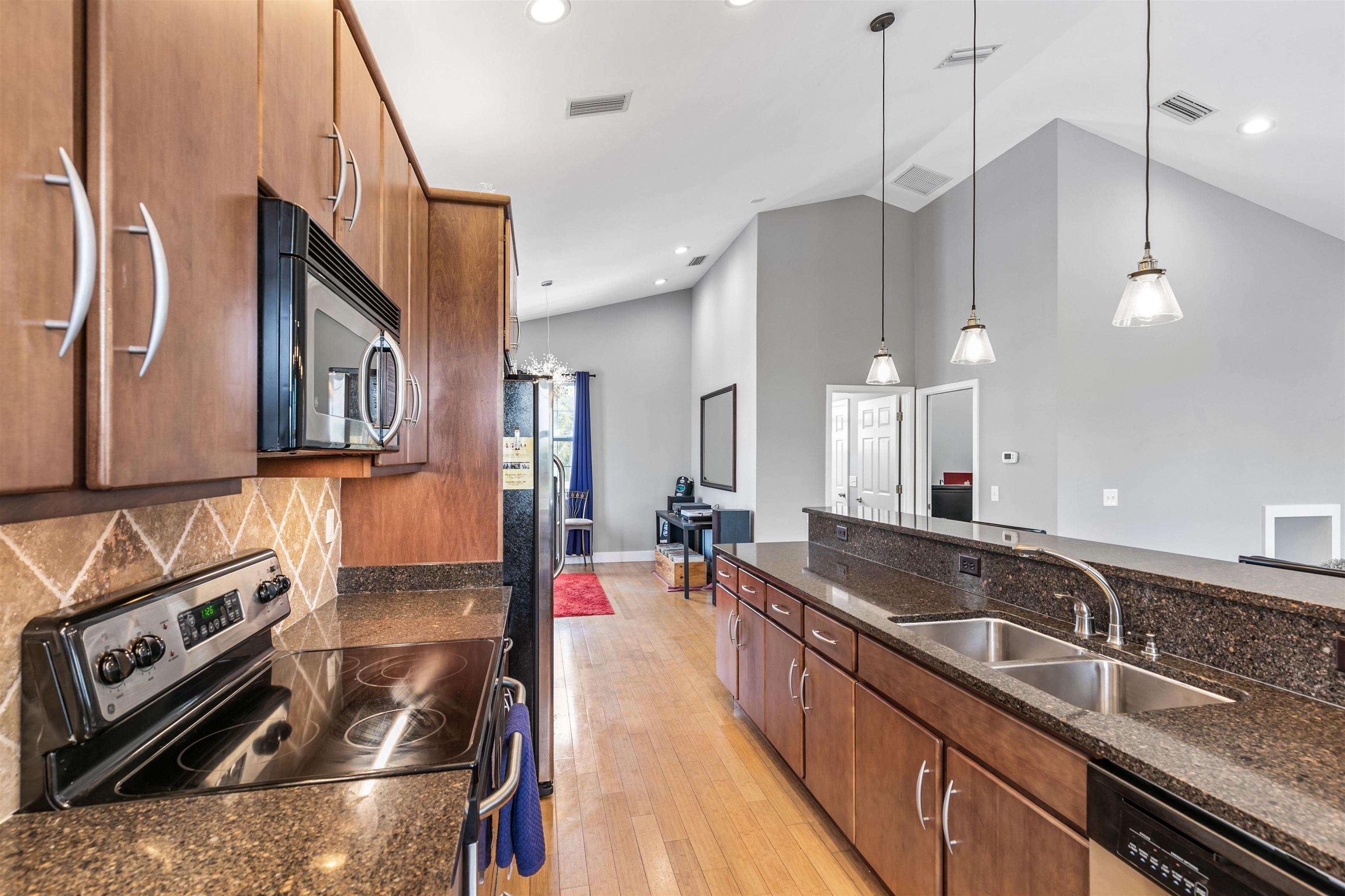 171 Riberia Street St. Augustine, FL 32084 - Photo 21 of 33 a kitchen with a sink stove and cabinets