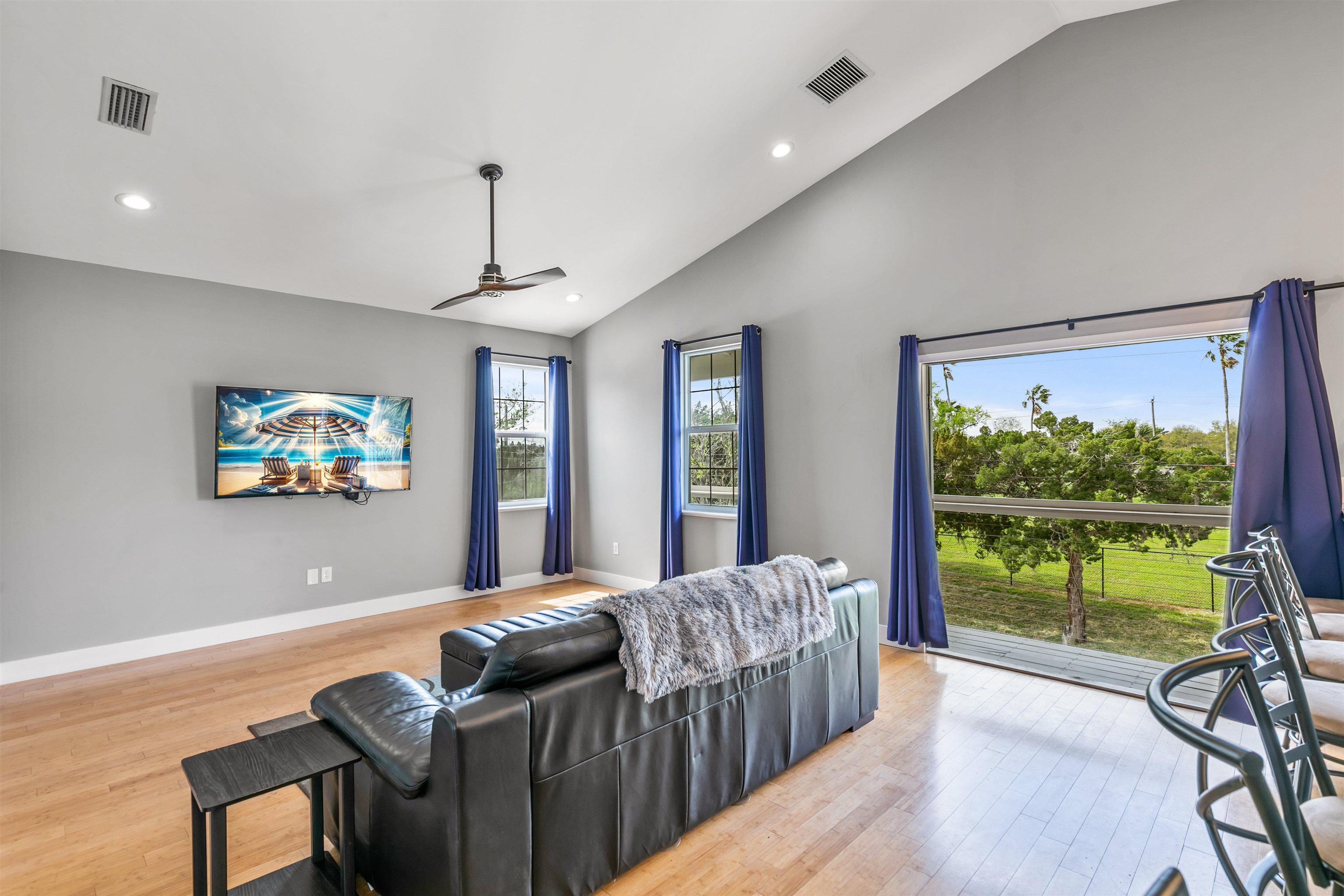 171 Riberia Street St. Augustine, FL 32084 - Photo 24 of 33 a living room with furniture a large window and a flat screen tv