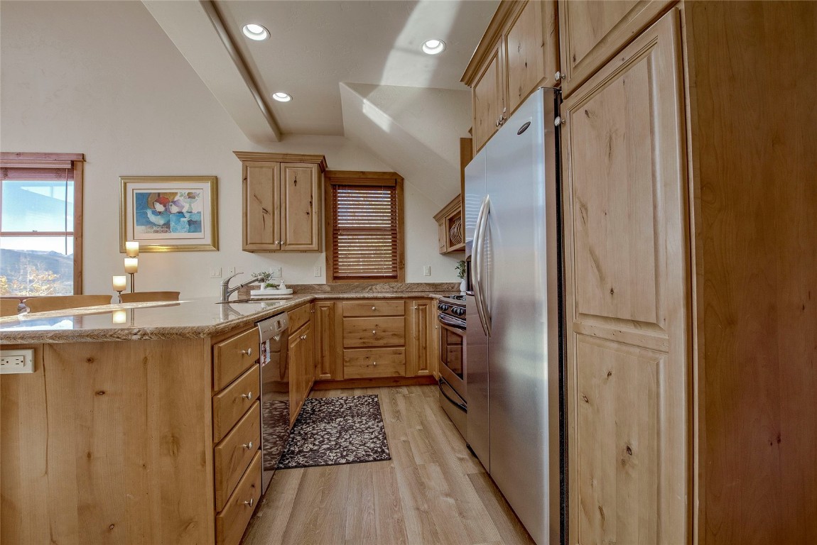 65 Antler Gulch Road, Unit 502 Keystone, CO 80435 - Photo 12 of 41 a kitchen with granite countertop a refrigerator and a sink