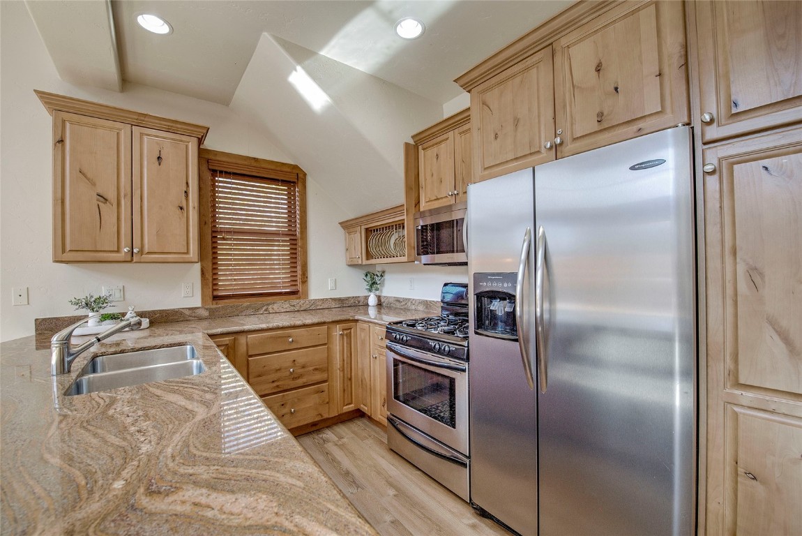 65 Antler Gulch Road, Unit 502 Keystone, CO 80435 - Photo 13 of 41 a kitchen with granite countertop stainless steel appliances a refrigerator stove top oven and sink