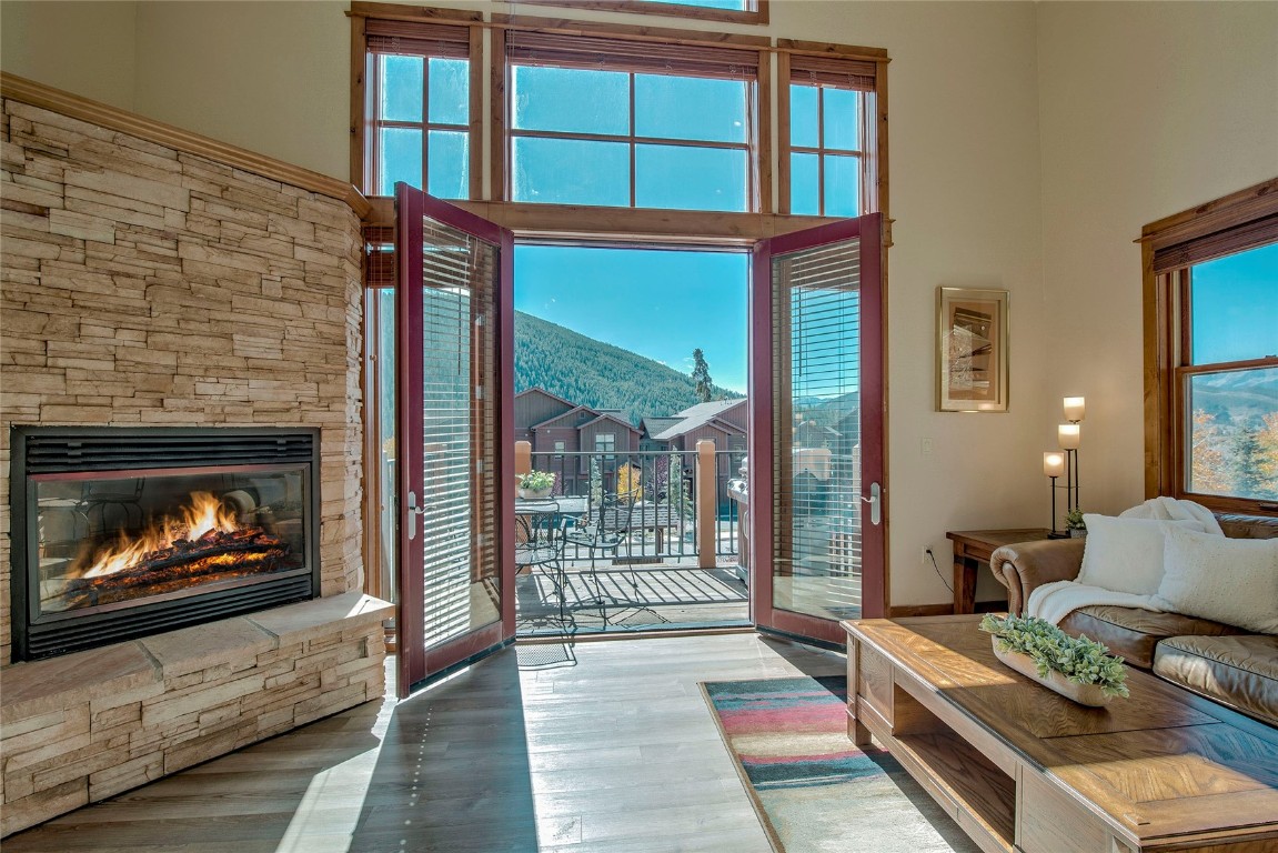 65 Antler Gulch Road, Unit 502 Keystone, CO 80435 - Photo 15 of 41 a living room with furniture a floor to ceiling window and a fireplace