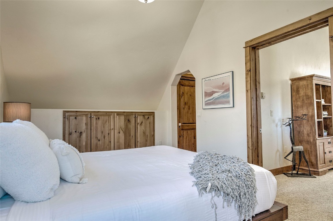 65 Antler Gulch Road, Unit 502 Keystone, CO 80435 - Photo 20 of 41 a bedroom with a bed and a large mirror