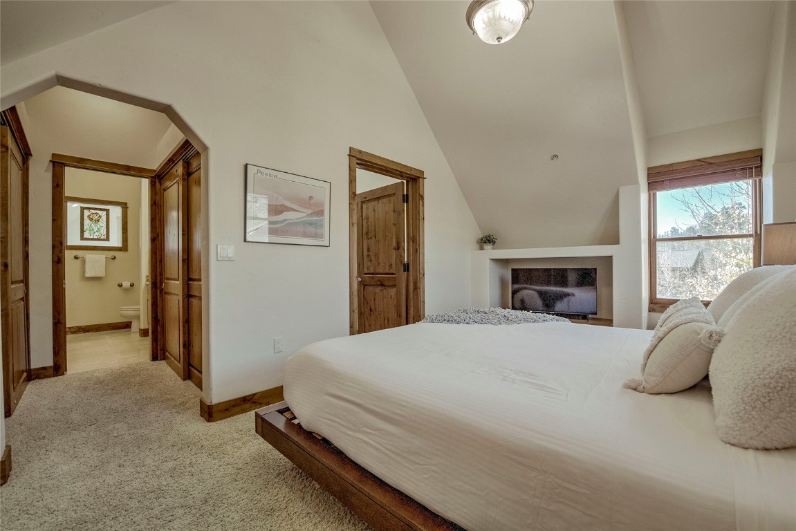 65 Antler Gulch Road, Unit 502 Keystone, CO 80435 - Photo 21 of 41 a bedroom with a bed and a fireplace