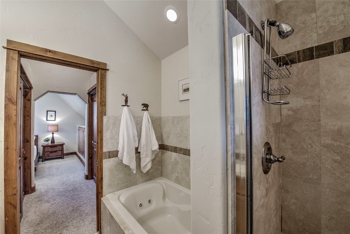 65 Antler Gulch Road, Unit 502 Keystone, CO 80435 - Photo 25 of 41 a bathroom with a tub a sink and mirrors