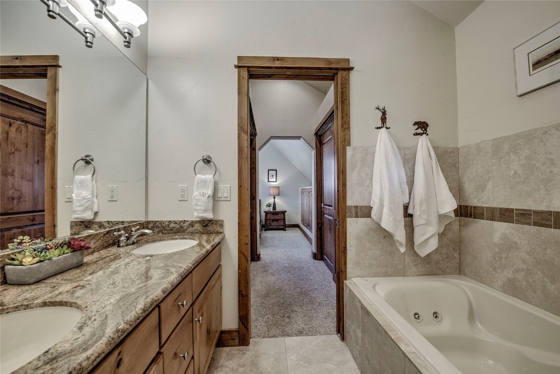 65 Antler Gulch Road, Unit 502 Keystone, CO 80435 - Photo 26 of 41 a en suite bathroom with a granite countertop sink and a mirror