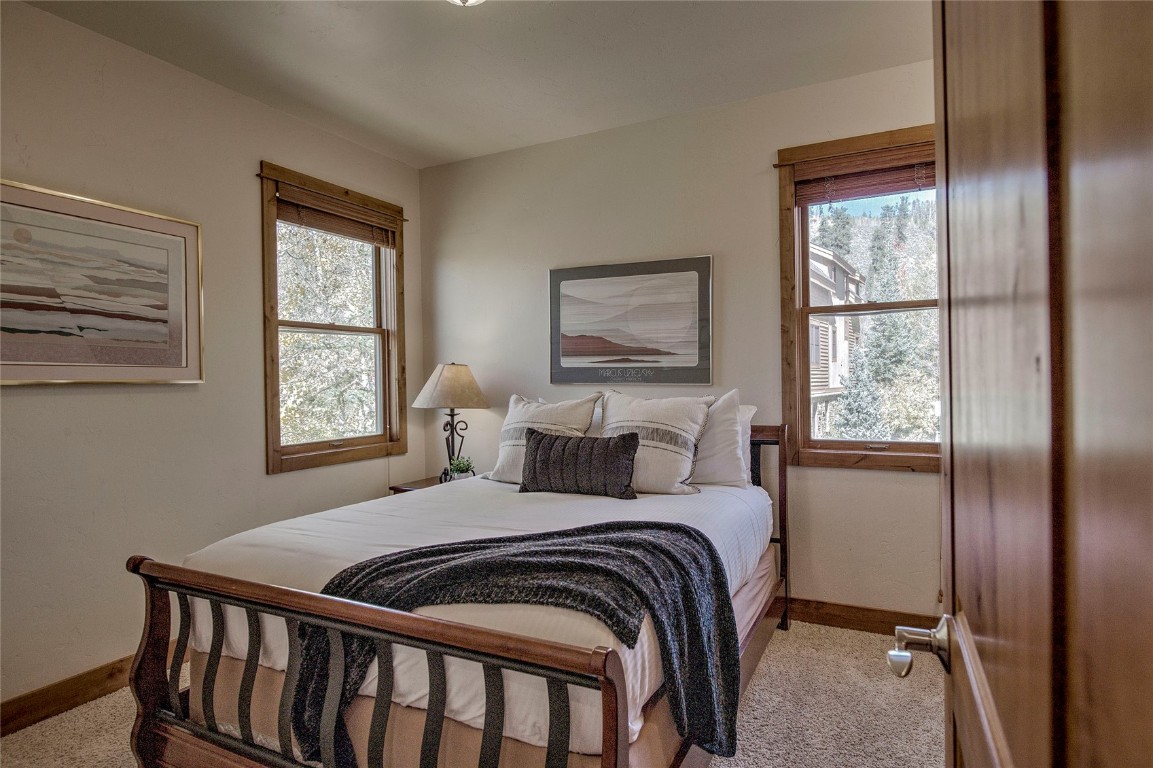65 Antler Gulch Road, Unit 502 Keystone, CO 80435 - Photo 31 of 41 a bedroom with a bed a window and painting on the wall
