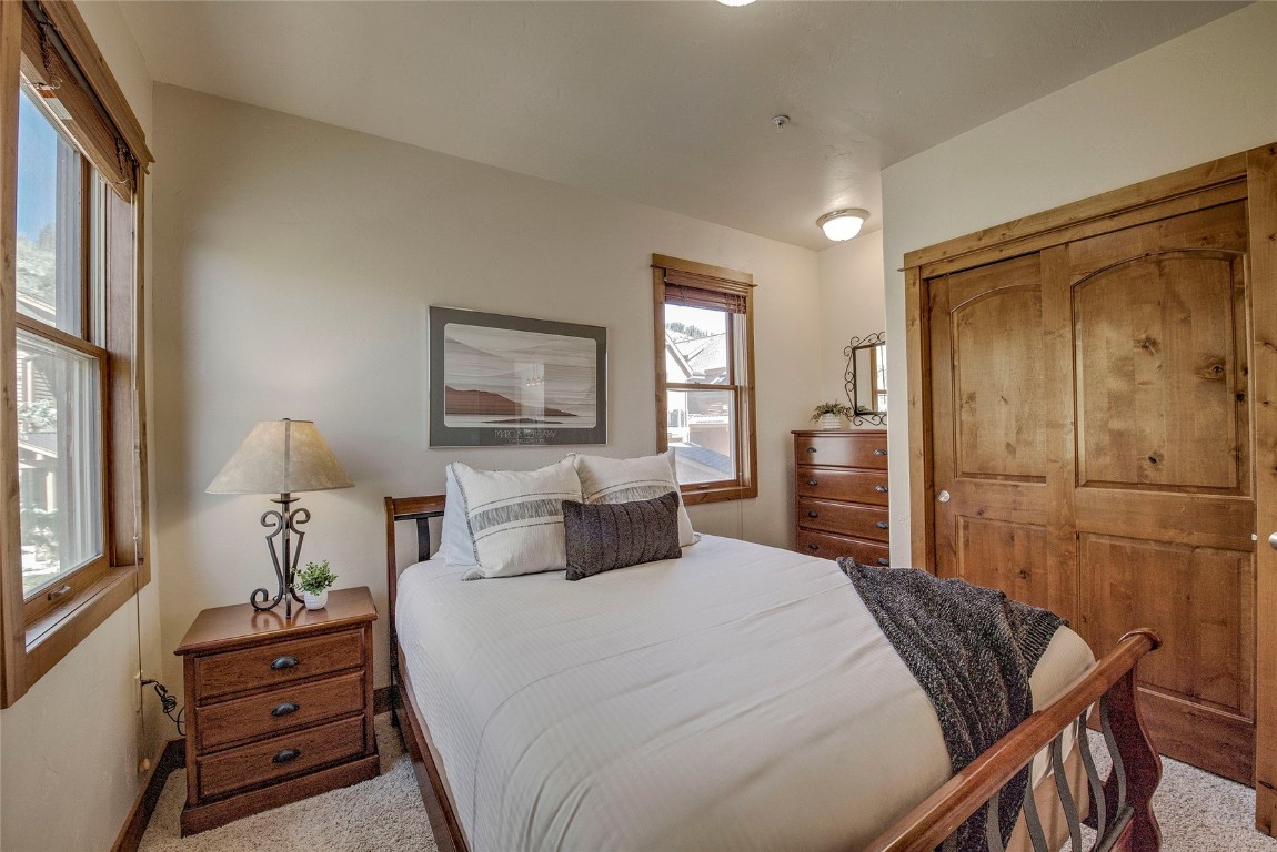 65 Antler Gulch Road, Unit 502 Keystone, CO 80435 - Photo 32 of 41 a bedroom with a bed and a dresser
