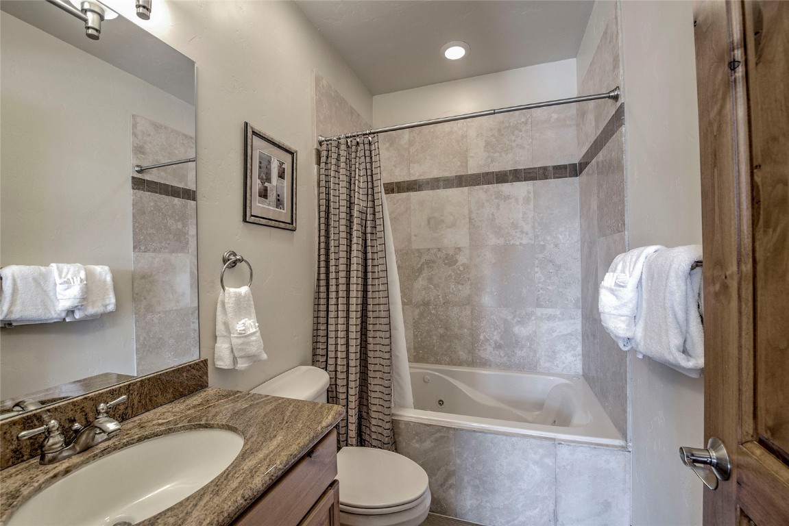 65 Antler Gulch Road, Unit 502 Keystone, CO 80435 - Photo 35 of 41 a bathroom with a sink toilet and shower