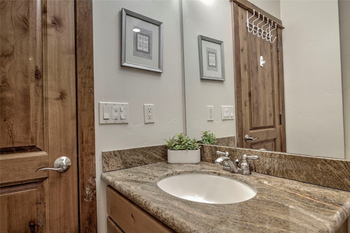 65 Antler Gulch Road, Unit 502 Keystone, CO 80435 - Photo 36 of 41 a bathroom with a granite countertop sink a mirror and shower