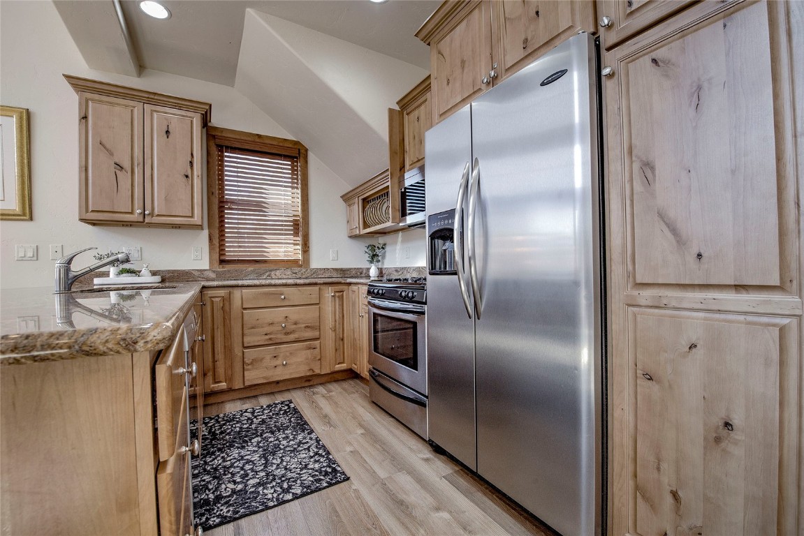65 Antler Gulch Road, Unit 502 Keystone, CO 80435 - Photo 8 of 41 a kitchen with a refrigerator sink and cabinets