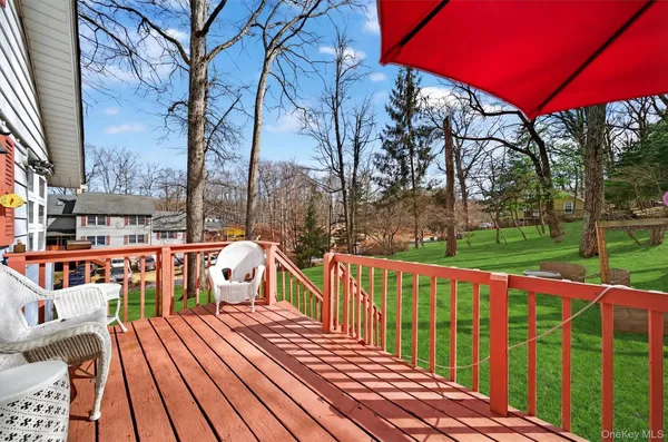 a view of a balcony with chairs and wooden floor