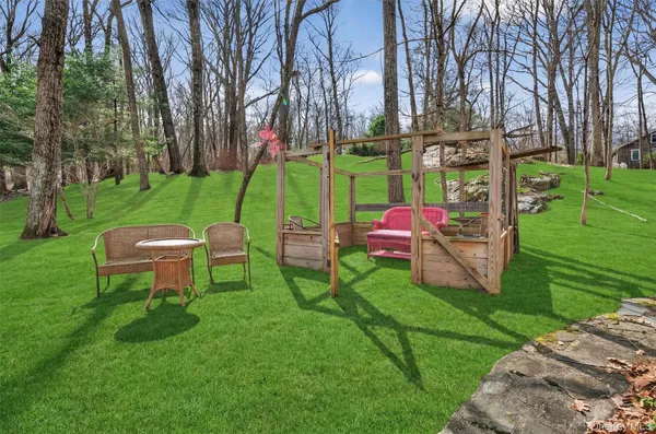 a backyard of a house with table and chairs