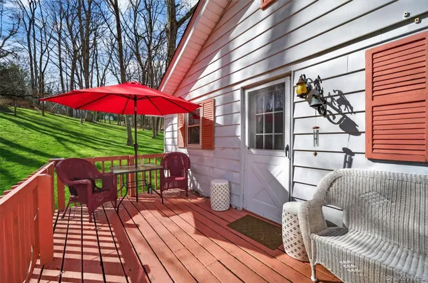 a view of balcony with wooden floor and outdoor seating