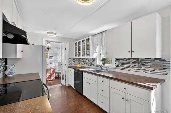 a kitchen with cabinets and window