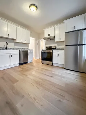 a kitchen with stainless steel appliances a refrigerator sink and cabinets