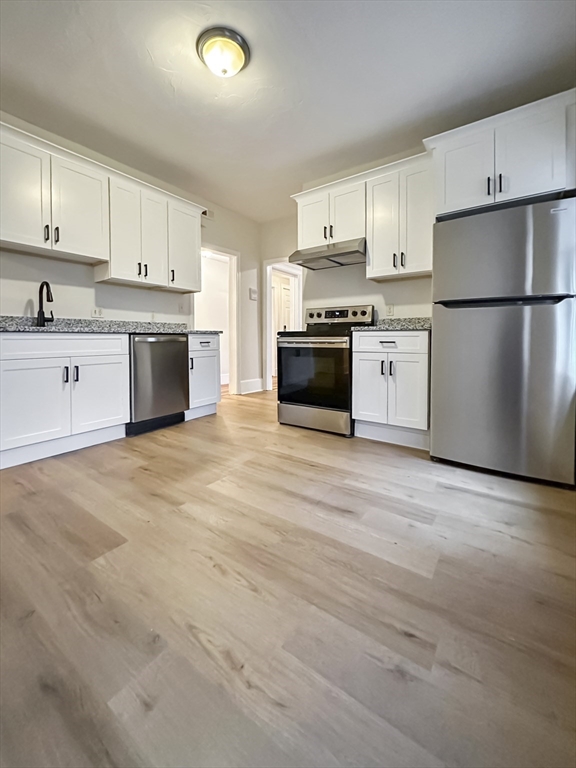 55 Hollander Street, Unit 2 Boston, MA 02121 - Photo 1 of 8 a kitchen with stainless steel appliances a refrigerator sink and cabinets