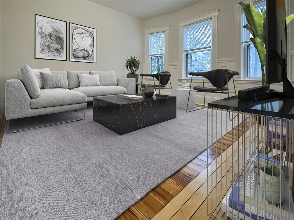 55 Hollander Street, Unit 2 Boston, MA 02121 - Photo 2 of 8 a living room with furniture ceiling fan and a window