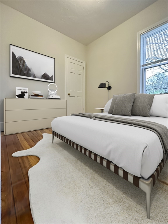 55 Hollander Street, Unit 2 Boston, MA 02121 - Photo 4 of 8 a bedroom with bed and window