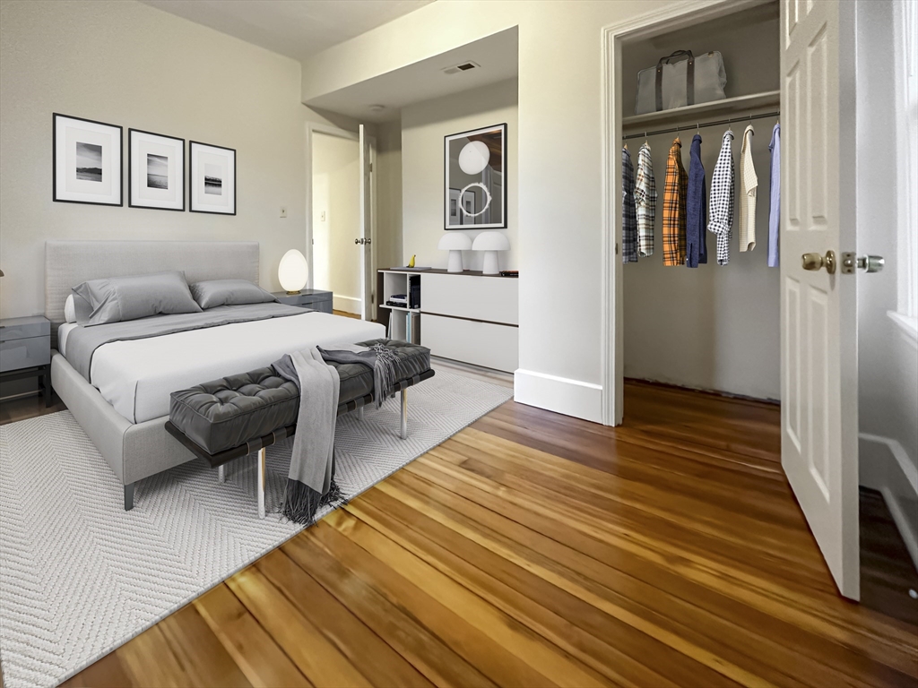 55 Hollander Street, Unit 2 Boston, MA 02121 - Photo 6 of 8 a spacious bedroom with two beds and a table