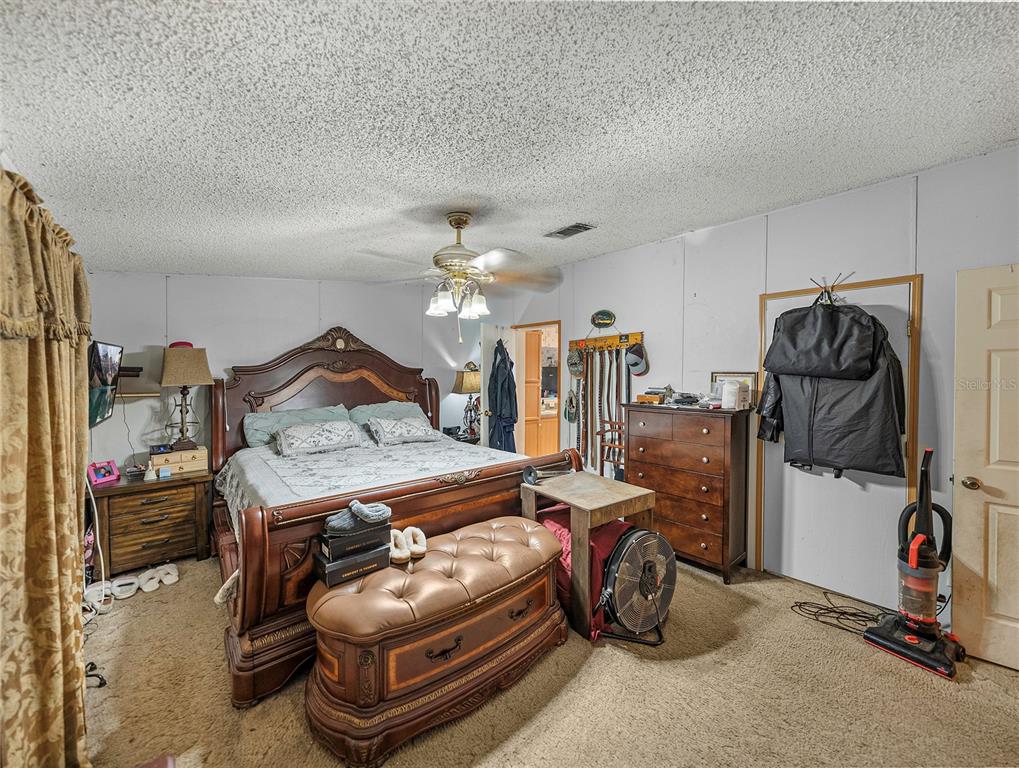 11404 Lithia Pinecrest Road Lithia, FL 33547 - Photo 31 of 63 a bedroom with a bed and gym equipment
